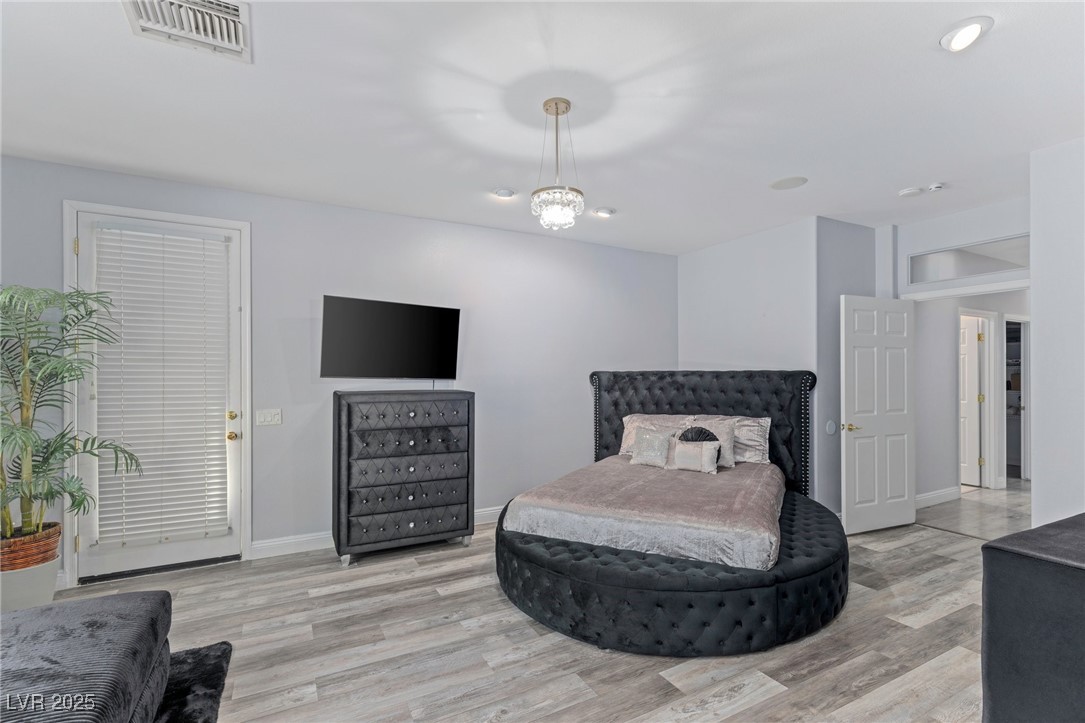 3 Chatmoss Road Henderson, NV 89052 - Photo 28 of 41 Bedroom with visible vents, baseboards, and wood finished floors