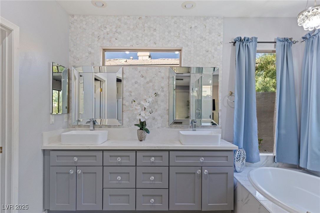 3 Chatmoss Road Henderson, NV 89052 - Photo 32 of 41 Bathroom with double vanity, a sink, and a garden tub
