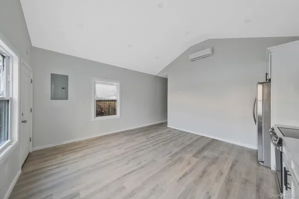 a view of a kitchen with wooden floor and electronic appliances