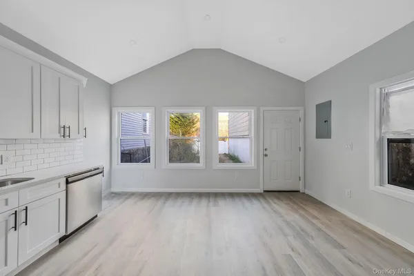 a kitchen with stainless steel appliances granite countertop a stove a refrigerator and a microwave