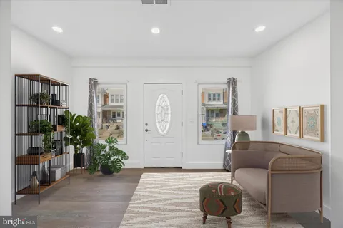 a living room with furniture and a potted plant
