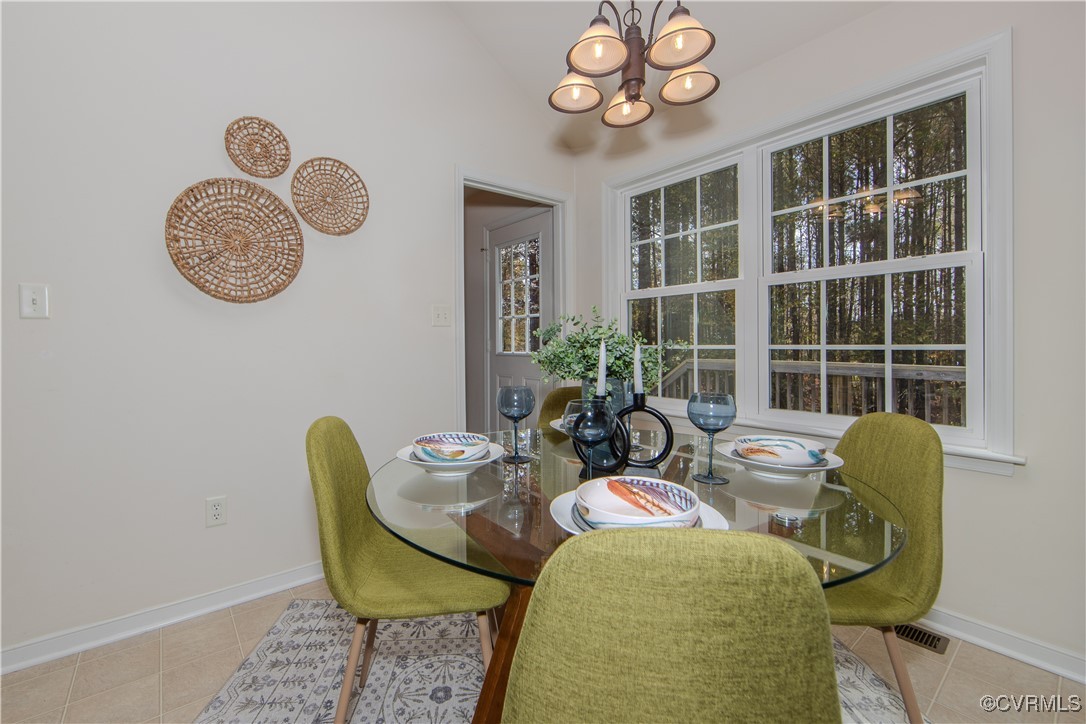 9595 Holdsworth Road Disputanta, VA 23842 - Photo 13 of 28 a view of a dining room with furniture and chandelier