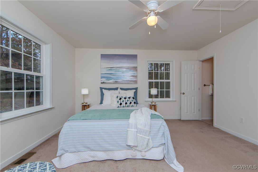 9595 Holdsworth Road Disputanta, VA 23842 - Photo 16 of 28 a spacious bedroom with a bed and a window