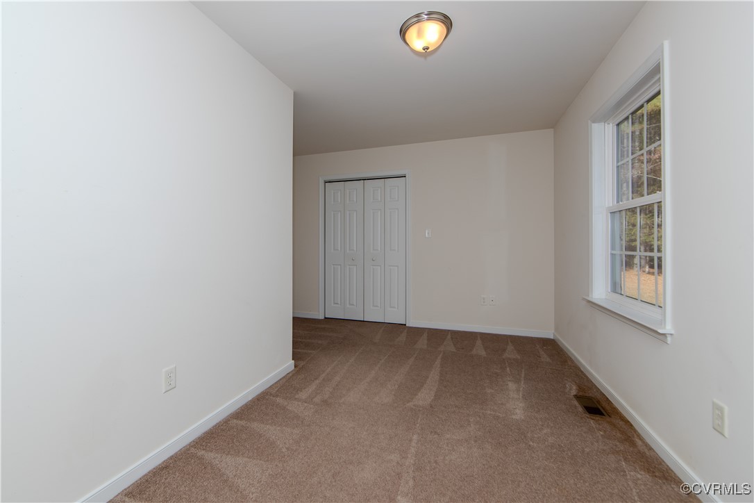 9595 Holdsworth Road Disputanta, VA 23842 - Photo 18 of 28 an empty room with windows