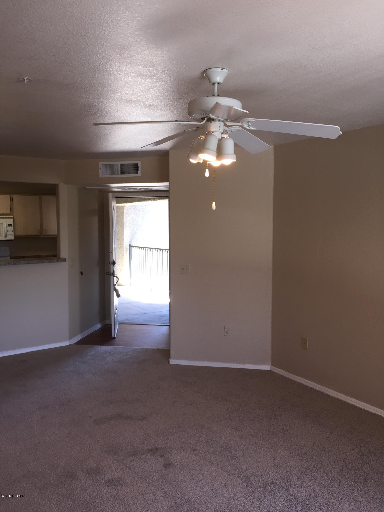 5751 North Kolb Road, Unit 28201 Tucson, AZ 85750 - Photo 4 of 14 a view of a livingroom with a ceiling fan and window