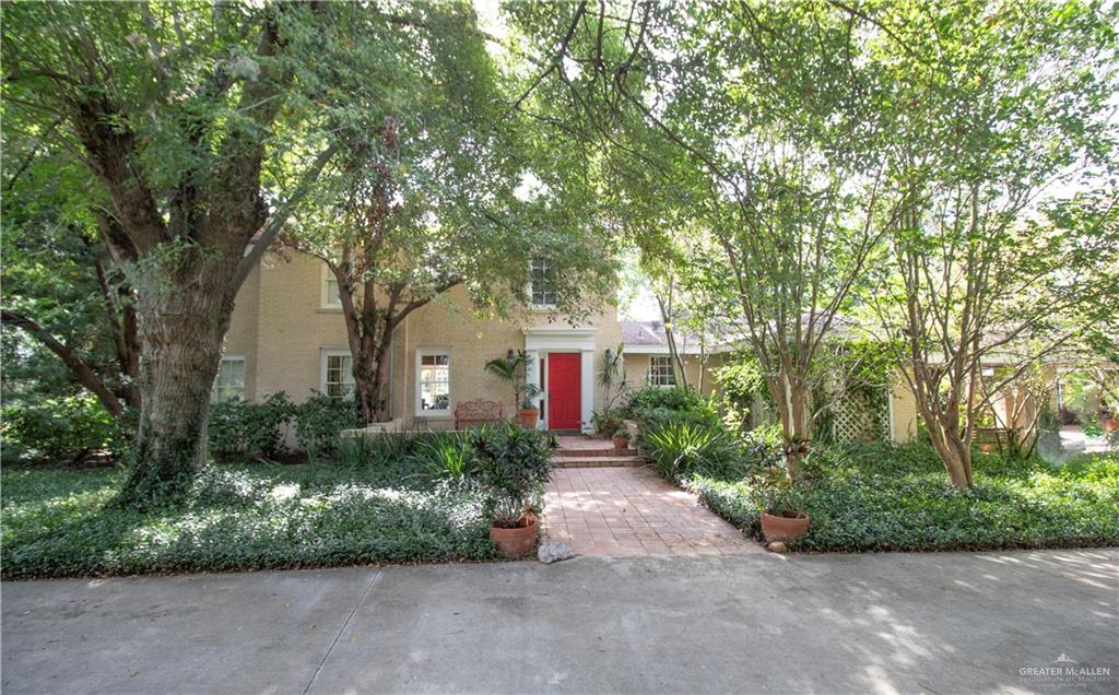 a front view of a house with a yard and outdoor seating