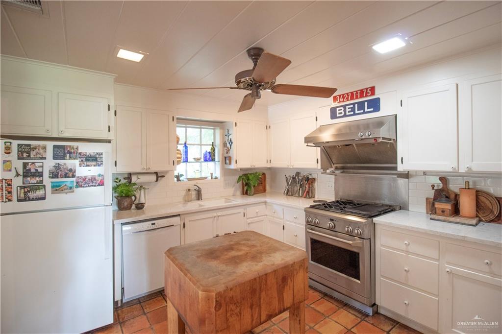 801 South River Road Donna, TX 78537 - Photo 13 of 35 a kitchen with white cabinets and appliances