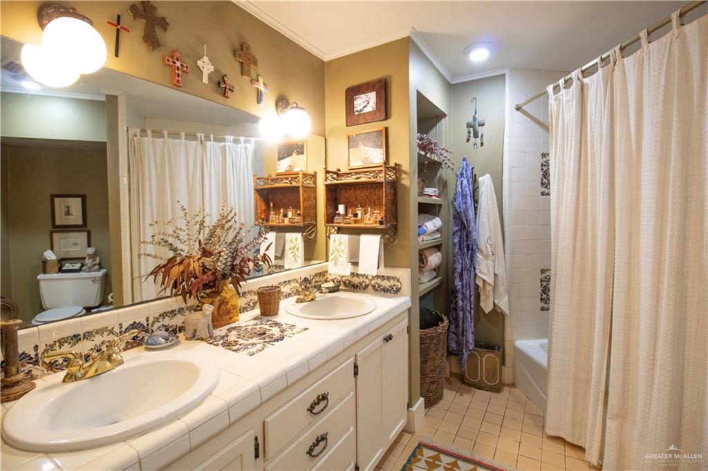 801 South River Road Donna, TX 78537 - Photo 16 of 35 a bathroom with a sink double vanity and a mirror
