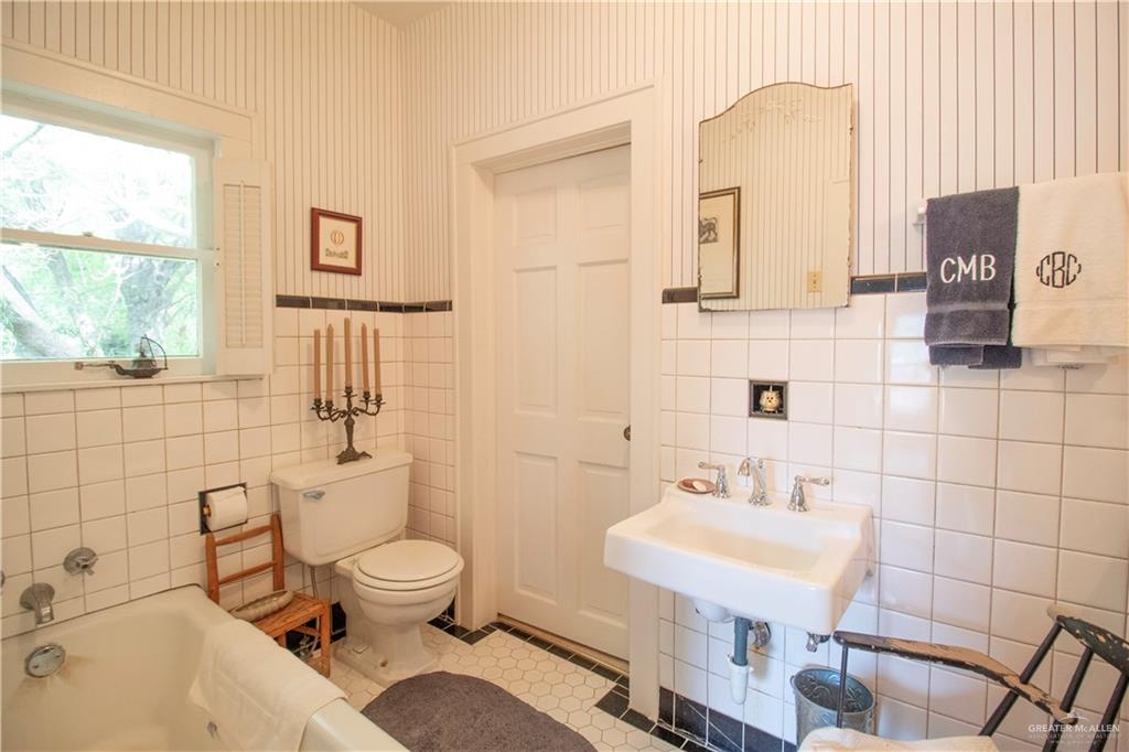 801 South River Road Donna, TX 78537 - Photo 18 of 35 a bathroom with a sink toilet a mirror and shower