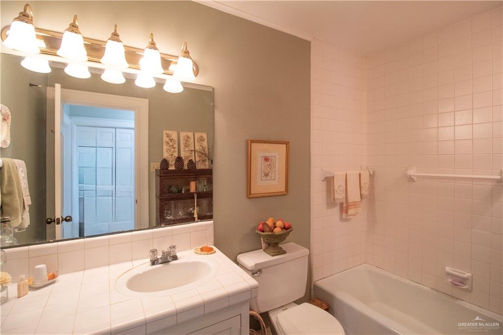 801 South River Road Donna, TX 78537 - Photo 21 of 35 a bathroom with a sink vanity granite toilet tub and shower