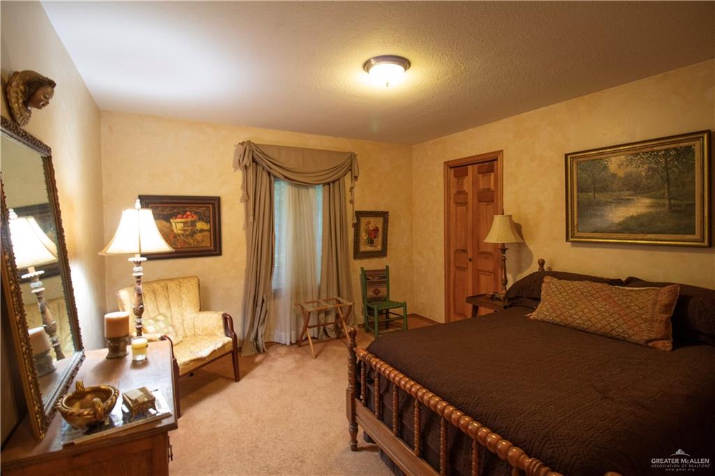 801 South River Road Donna, TX 78537 - Photo 31 of 35 a bedroom with bed and wooden floor