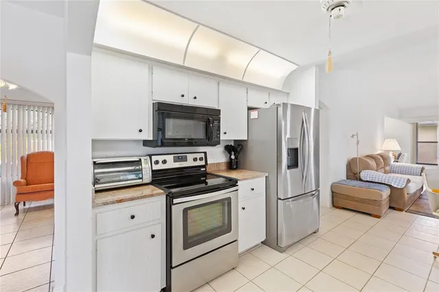 a kitchen with stainless steel appliances a stove microwave and a refrigerator