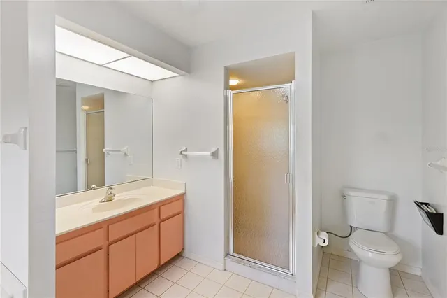 a bathroom with a double vanity sink toilet and shower