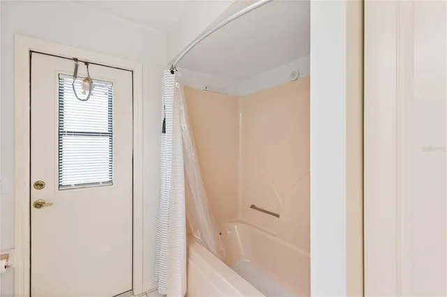 a bathroom with a bathtub and shower