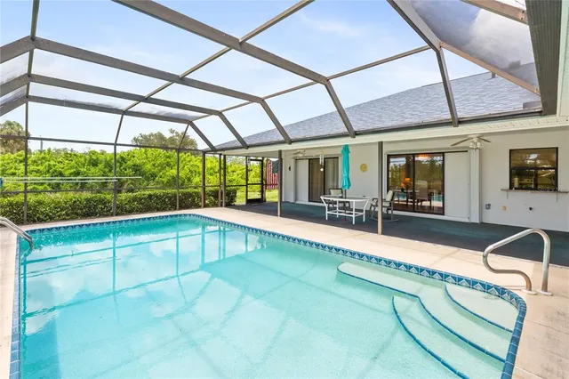 a view of a backyard with a swimming pool