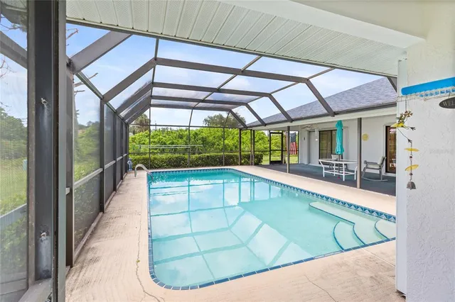 a view of a big house with a big yard plants and large trees