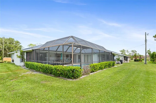 a view of a backyard with porch and garden