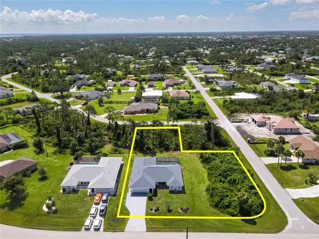 an aerial view of residential houses with outdoor space