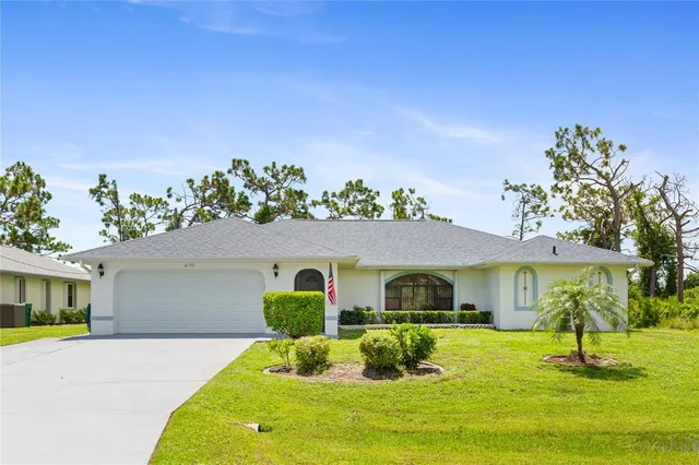 an aerial view of a house with swimming pool garden and patio