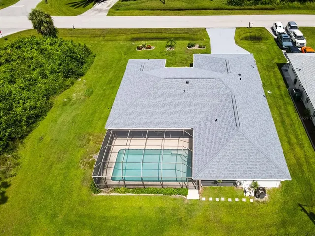 an aerial view of a residential houses with outdoor space and a lake view