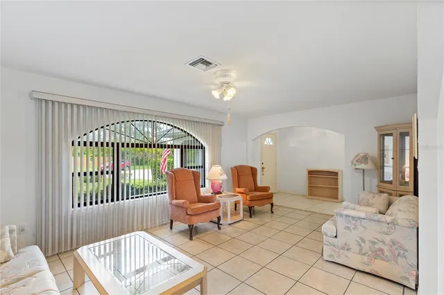 a living room with furniture a fireplace and a large window