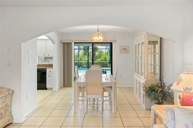 a dining room with furniture a chandelier and a rug