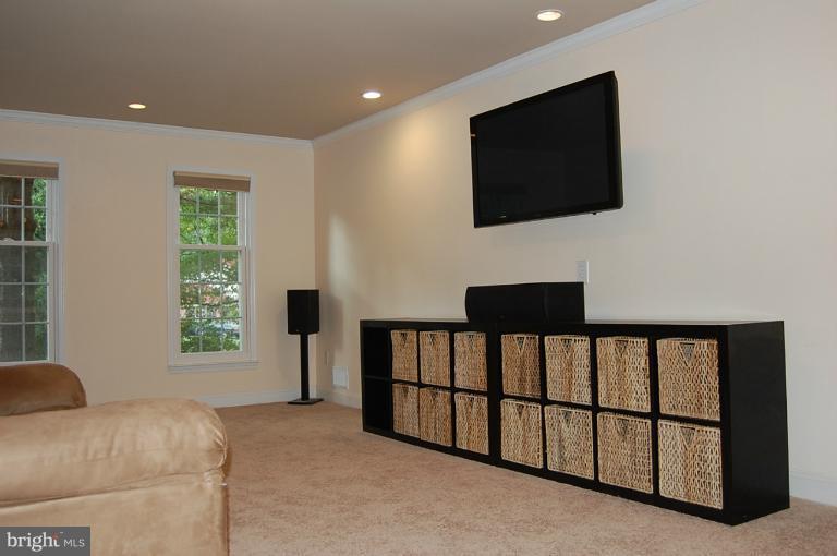 12326 Coleraine Court Reston, VA 20191 - Photo 22 of 29 a living room with furniture and a flat screen tv