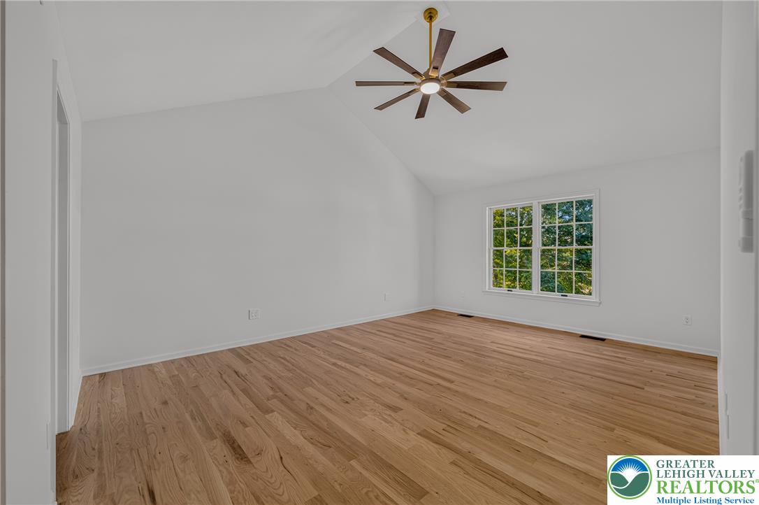 3130 Muirfield Road Center Valley, PA 18034 - Photo 30 of 63 Hardwood floors and a vaulted ceiling elevate this airy, versatile living space.