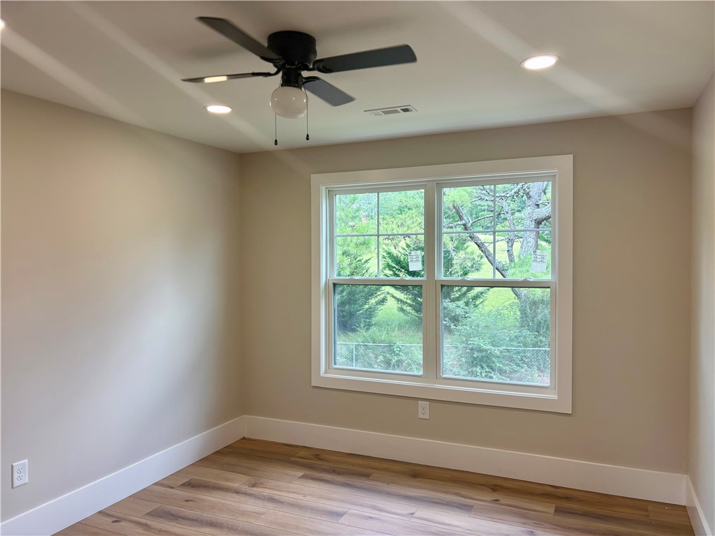 854 Perkins Creek Road Seneca, SC 29678 - Photo 32 of 34 Rich wood flooring pairs beautifully with the surrounding nature views through a classic window.