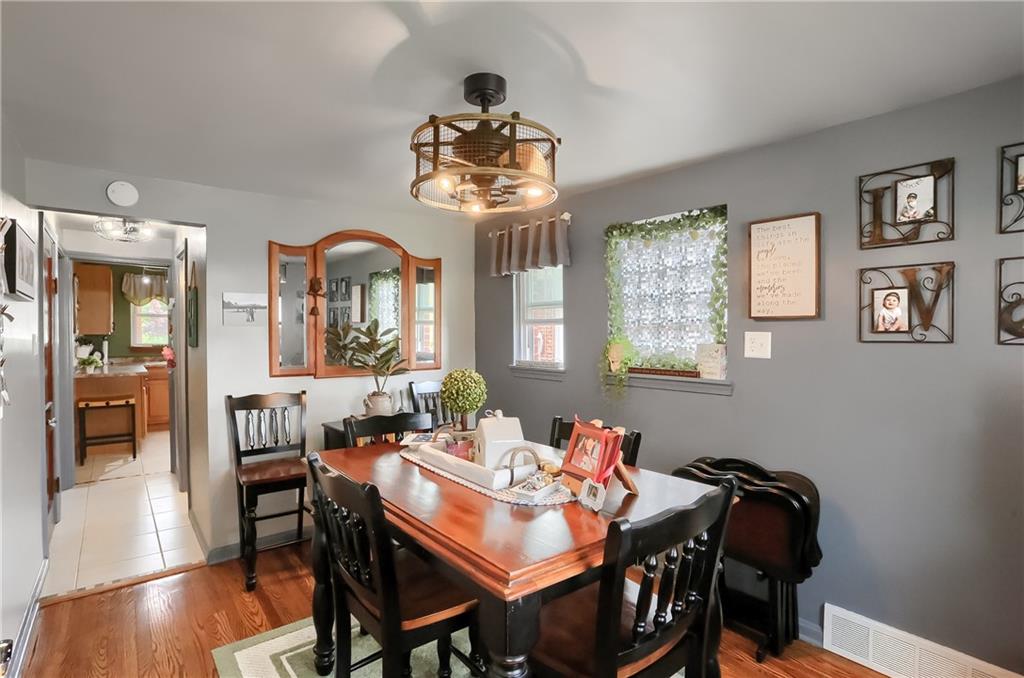 301 Wright Street McKees Rocks, PA 15136 - Photo 8 of 27 a view of a dining room with furniture wooden floor and a chandelier