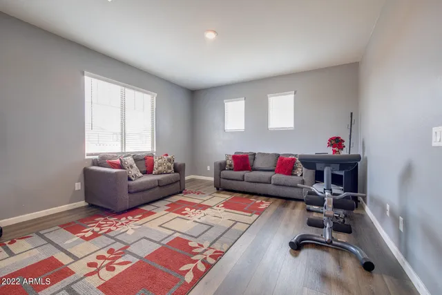 a living room with furniture and a wooden floor