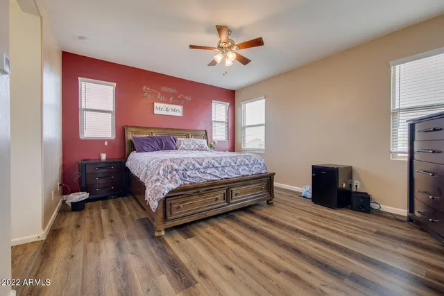 a bedroom with a bed and a chandelier