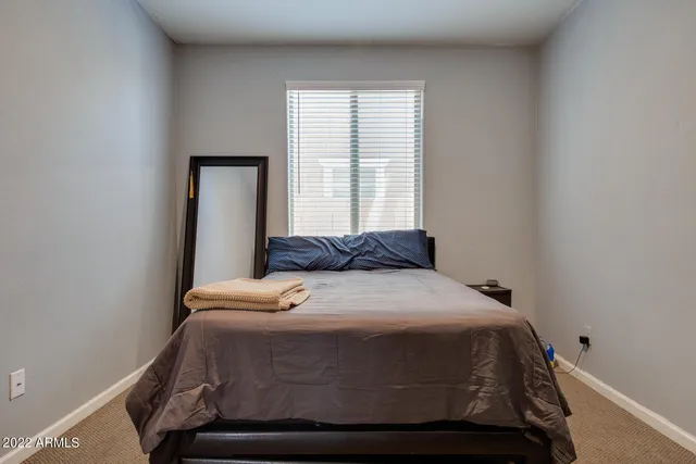 a bedroom with a bed and window