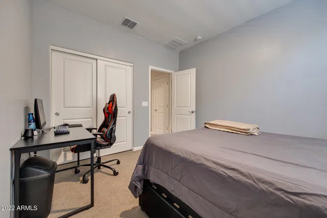 a bedroom with a workspace