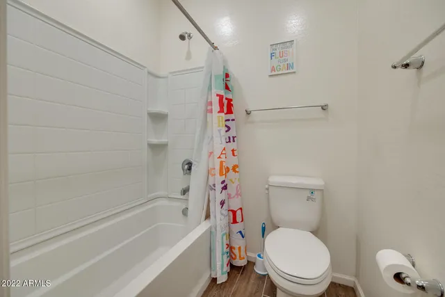 a bathroom with a toilet and shower
