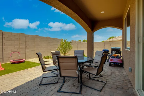 a view of a patio with table and chairs and potted plants