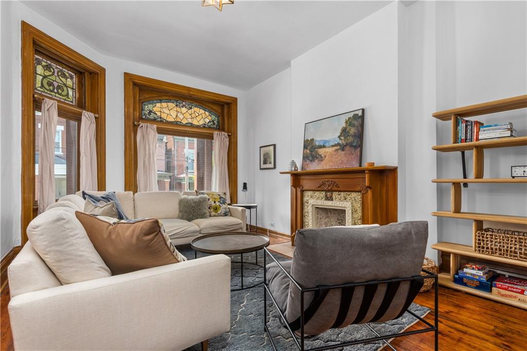 243 Fisk Street Pittsburgh, PA 15201 - Photo 12 of 34 a living room with furniture a bookshelf and a window
