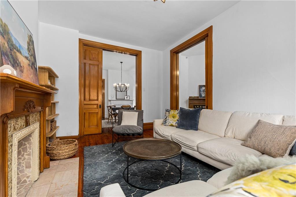 243 Fisk Street Pittsburgh, PA 15201 - Photo 13 of 34 a living room with furniture and a fireplace