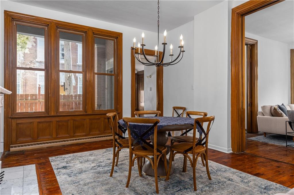 243 Fisk Street Pittsburgh, PA 15201 - Photo 15 of 34 a dining room with furniture window and wooden floor
