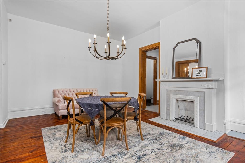 243 Fisk Street Pittsburgh, PA 15201 - Photo 16 of 34 a view of a dining room with furniture wooden floor and chandelier