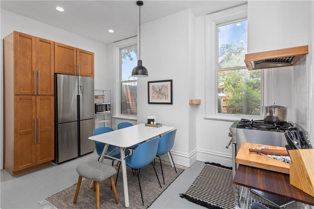 243 Fisk Street Pittsburgh, PA 15201 - Photo 21 of 34 a kitchen with stainless steel appliances granite countertop a refrigerator and a stove top oven