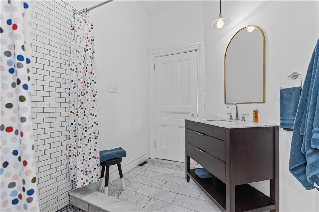 243 Fisk Street Pittsburgh, PA 15201 - Photo 26 of 34 a bathroom with a sink a toilet and a mirror