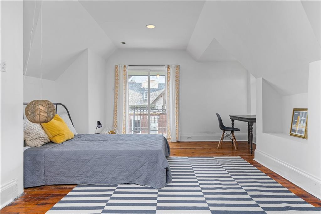 243 Fisk Street Pittsburgh, PA 15201 - Photo 27 of 34 a bedroom with a bed and wooden floor