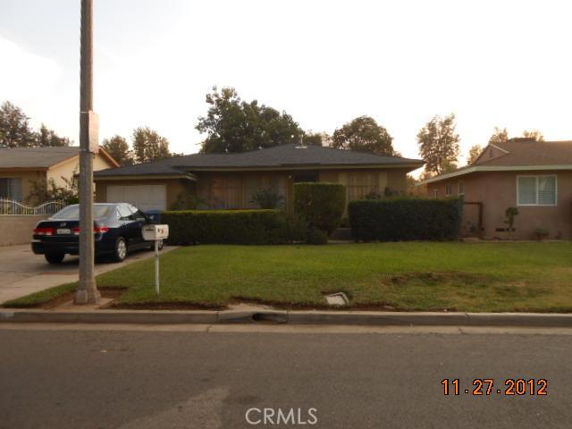 2730 Pleasant Street Riverside, CA 92507 - Photo 1 of 1 a front view of a house with a garden and yard