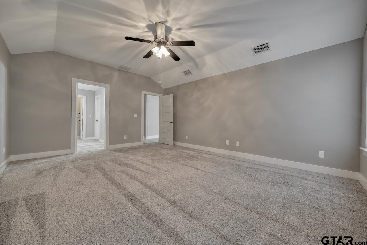 15342 Spring Oaks Drive Lindale, TX 75771 - Photo 22 of 45 an empty room with chandelier fan and windows