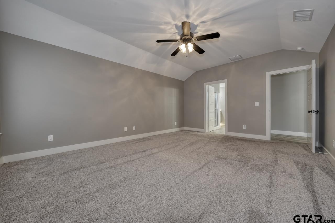 15342 Spring Oaks Drive Lindale, TX 75771 - Photo 23 of 45 a view of an empty room with a chandelier fan