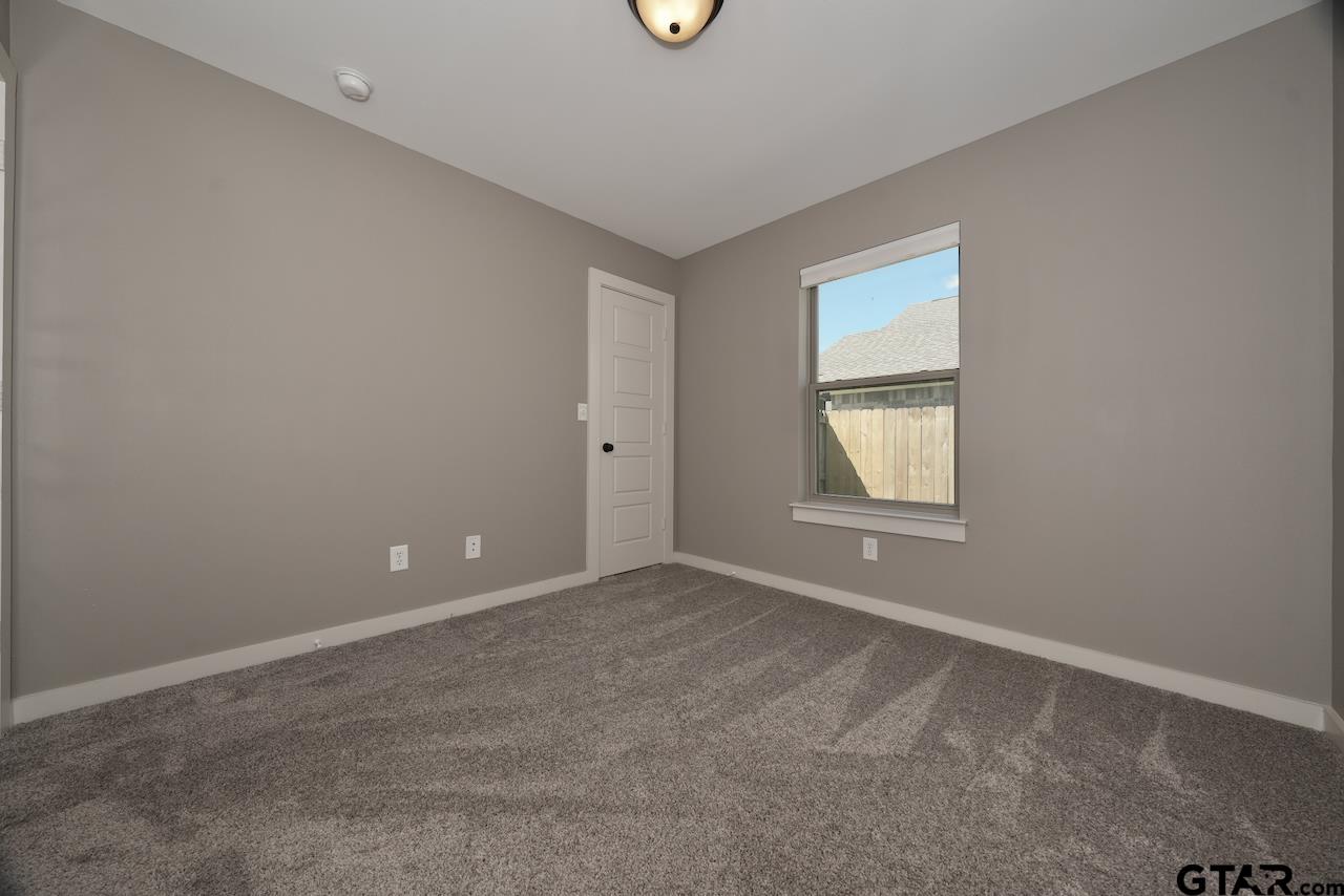 15342 Spring Oaks Drive Lindale, TX 75771 - Photo 36 of 45 an empty room with a window and a fan