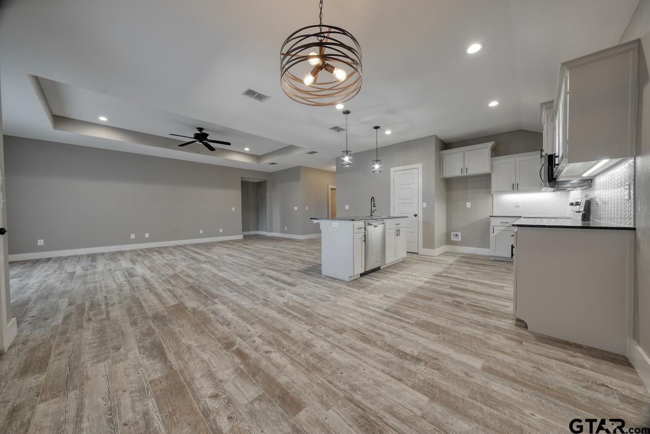 15342 Spring Oaks Drive Lindale, TX 75771 - Photo 9 of 45 a view of kitchen with granite countertop cabinets and refrigerator