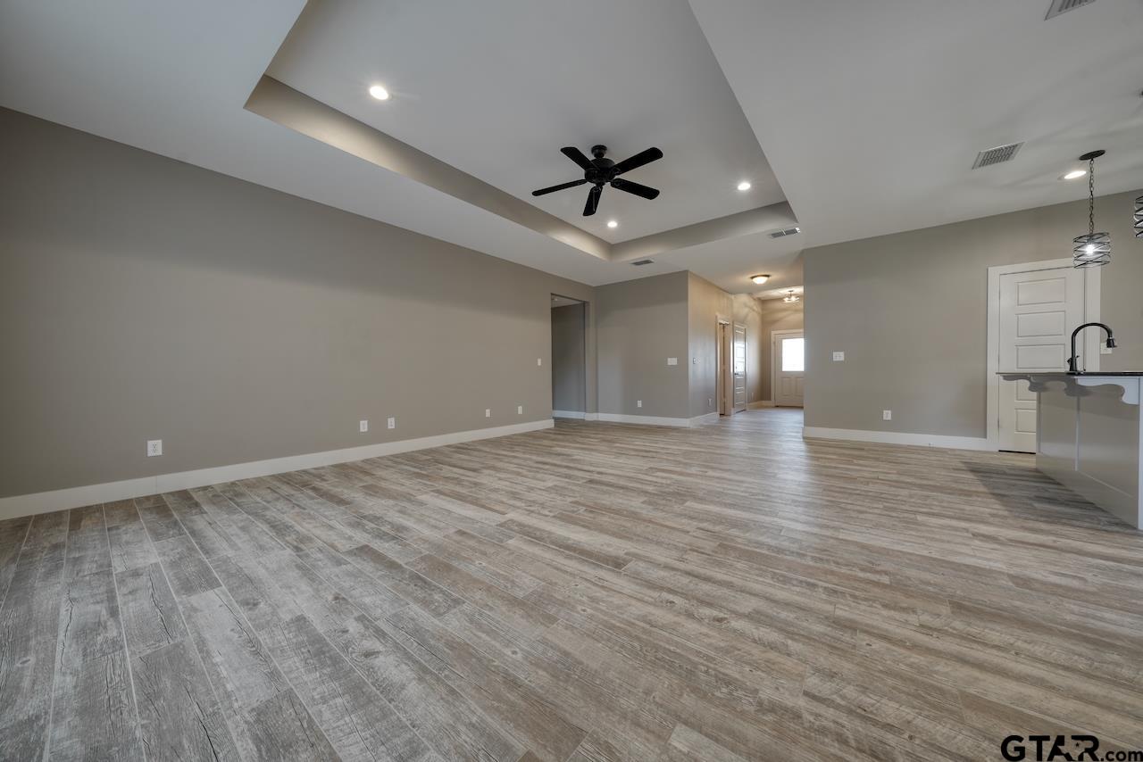 15342 Spring Oaks Drive Lindale, TX 75771 - Photo 10 of 45 an empty room with wooden floor and windows