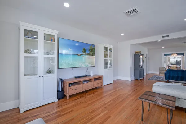a living room with furniture and a wooden floor